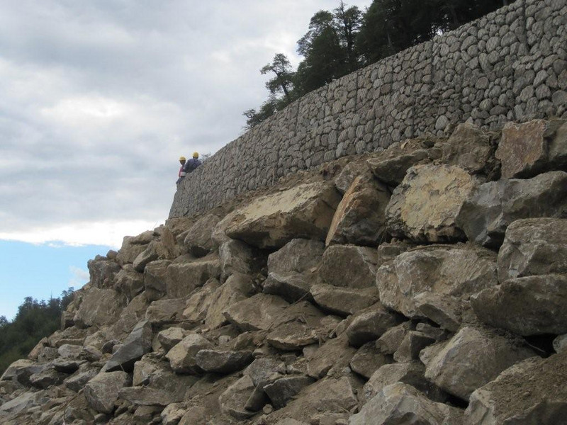 The stone walls, neatly stacked and enclosed in wire boxes.